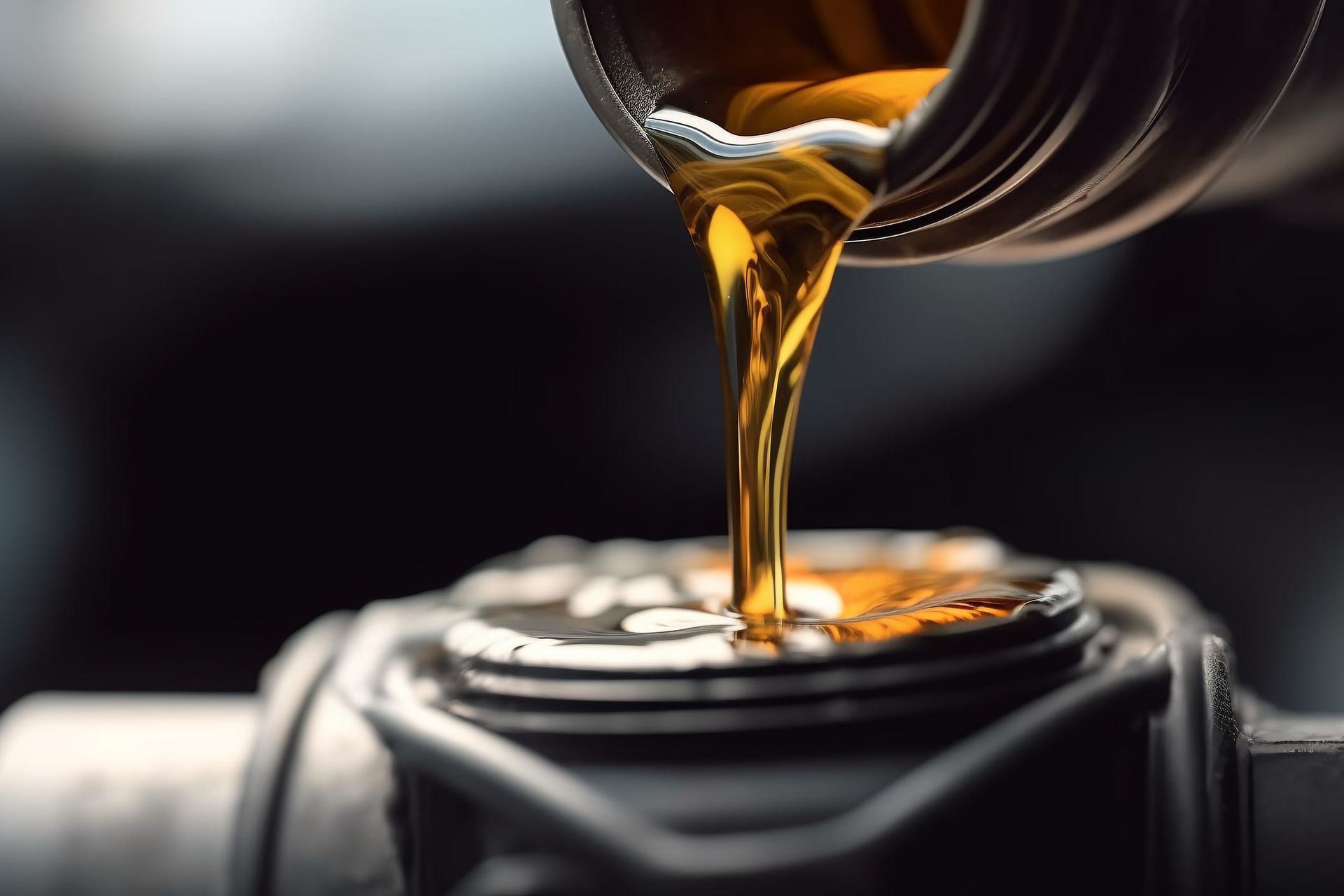Pouring engine oil into a car engine